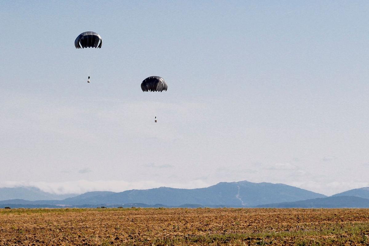Cargo bundles descending under parachutes