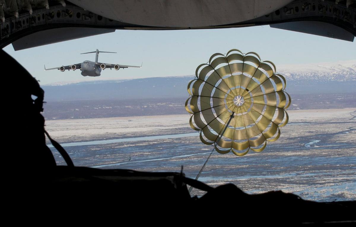 Cargo parachute opening behind a C-17
